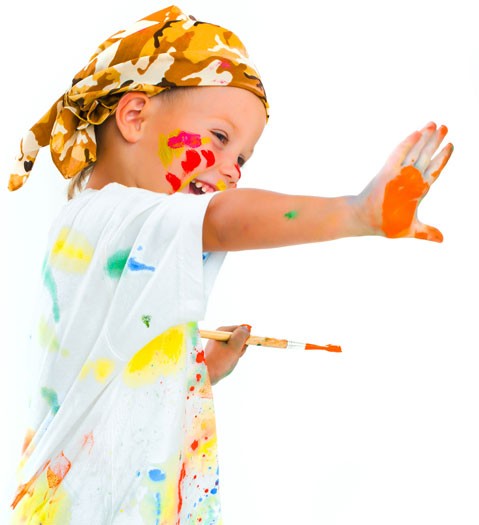 a child with paint on his hands and face holding his palm up